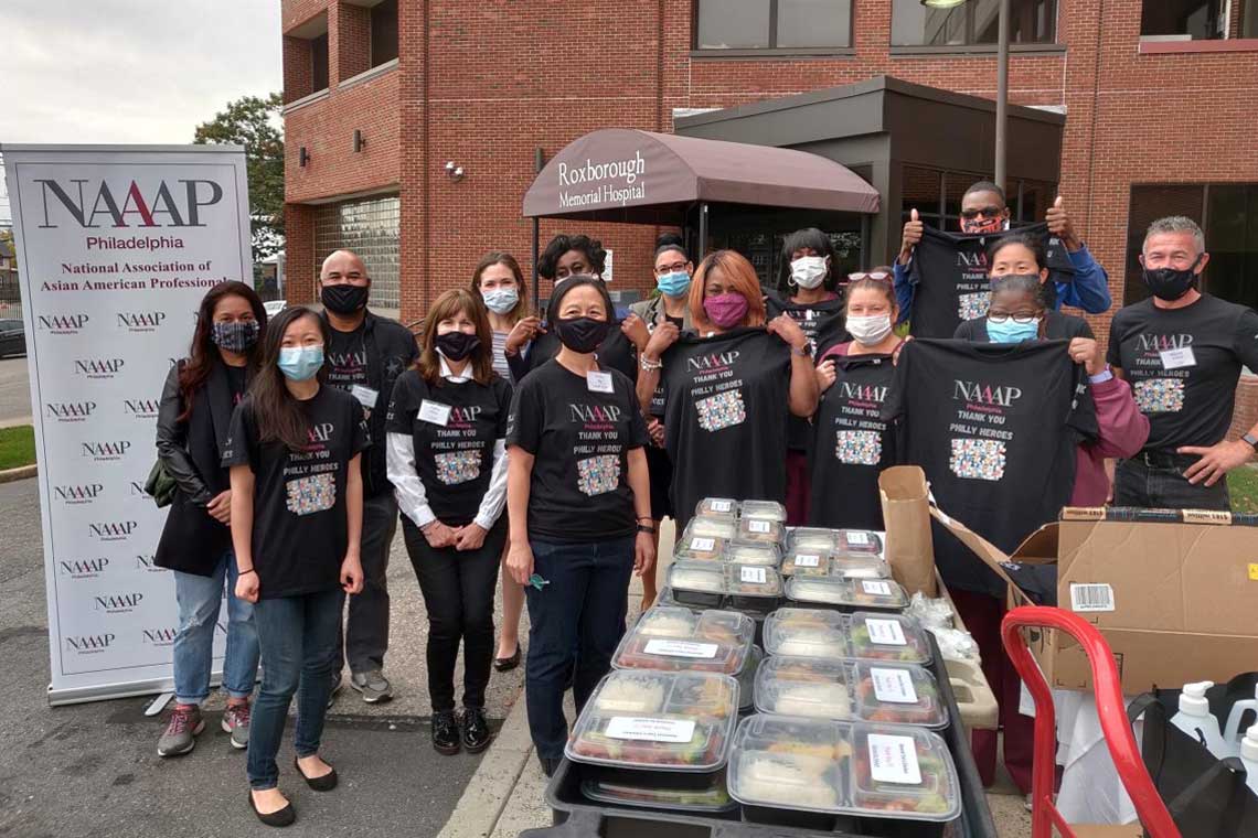 group in front of roxborough hospital with food package