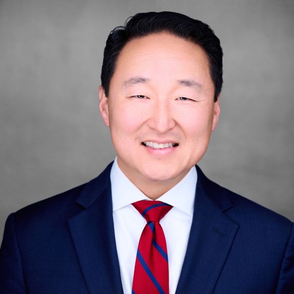 male with blue jacket and red tie