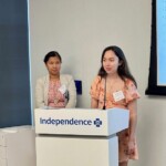 2 young adults standing near lectern
