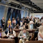 people standing, sitting and eating